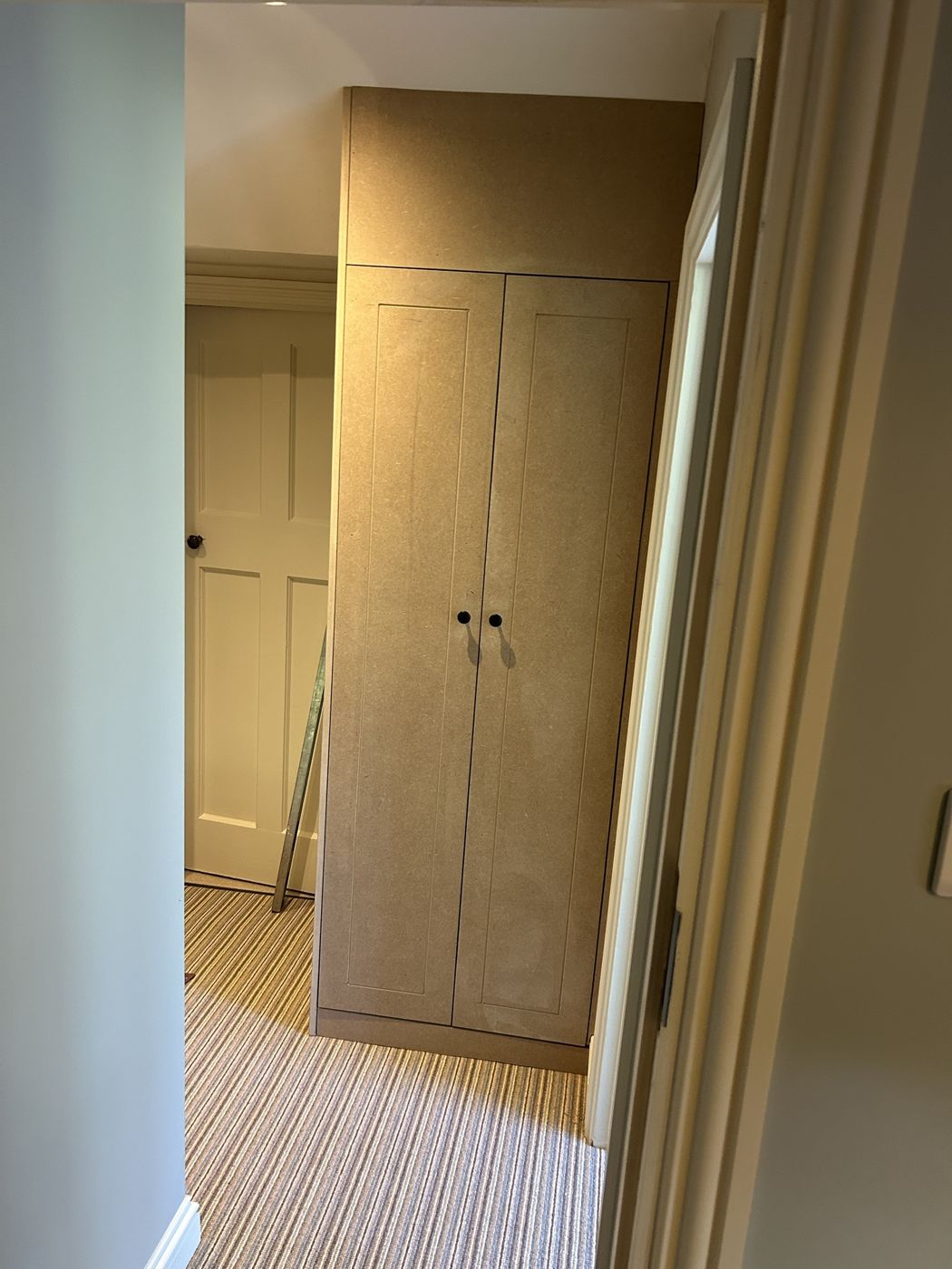 Tall two-door Shaker-style alcove cupboard with a top box