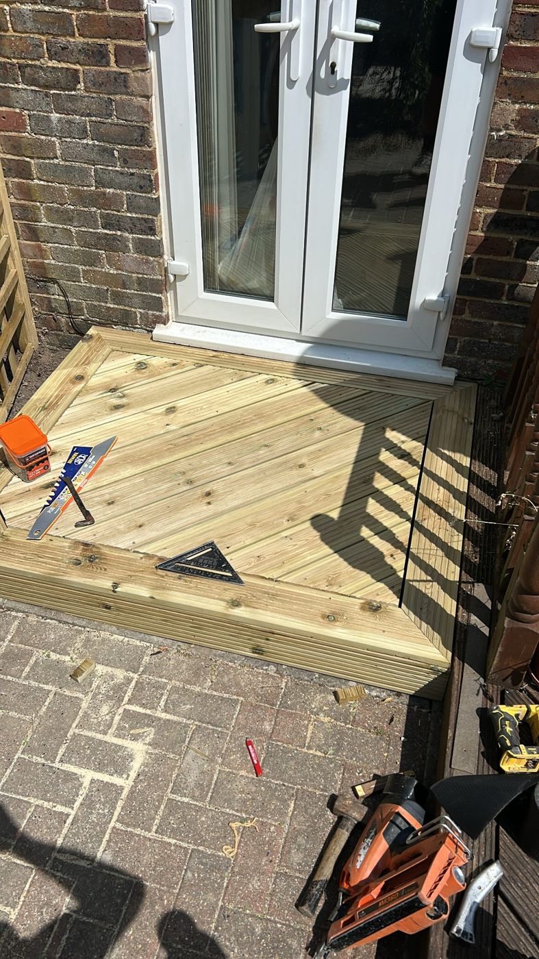 Diagonal-board timber deck step outside French doors