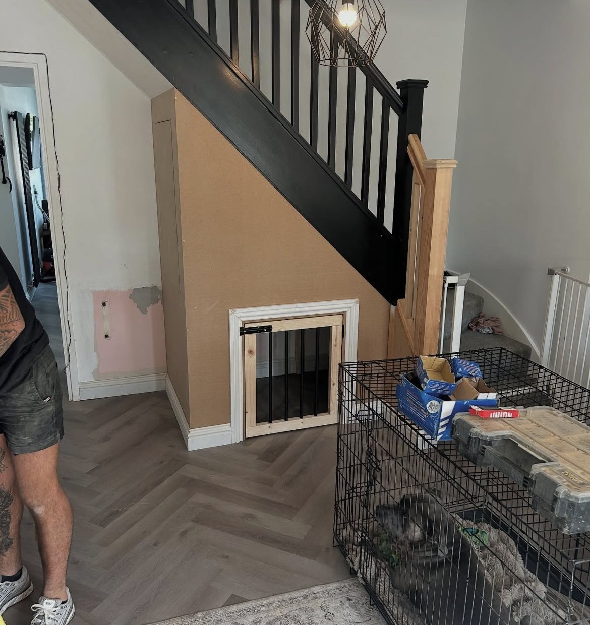 Under-stairs storage with a built-in dog kennel door