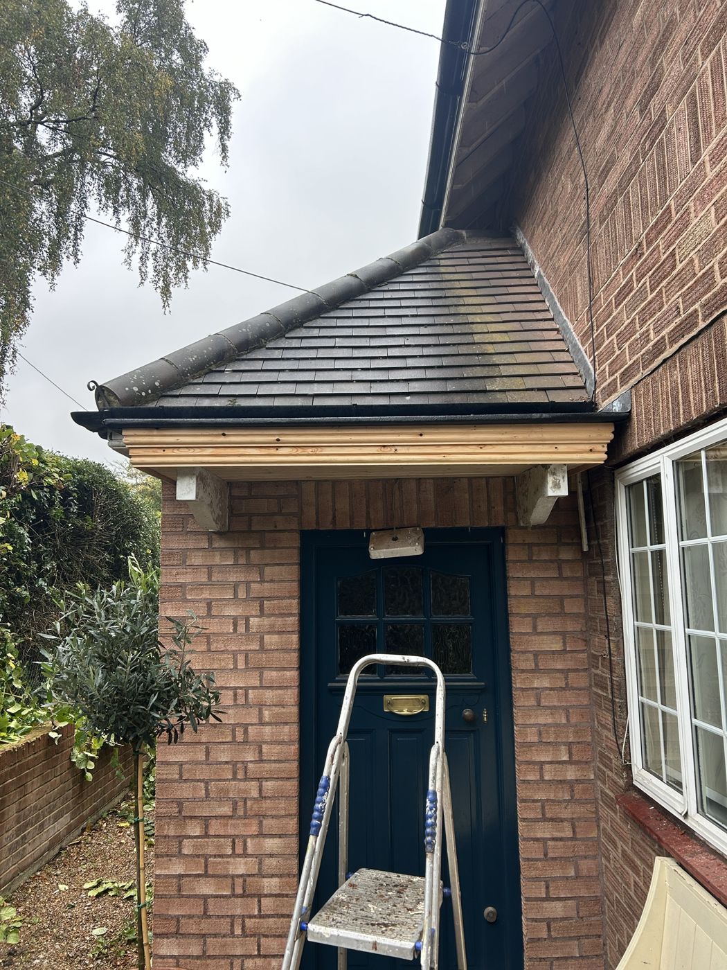 Front porch with new moulded timber fascia under a clay-tiled roof